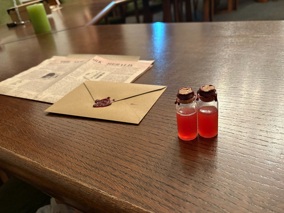 Sealed envelope and two small bottles on the table