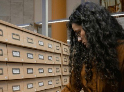 Picture of a student near a desk with cards