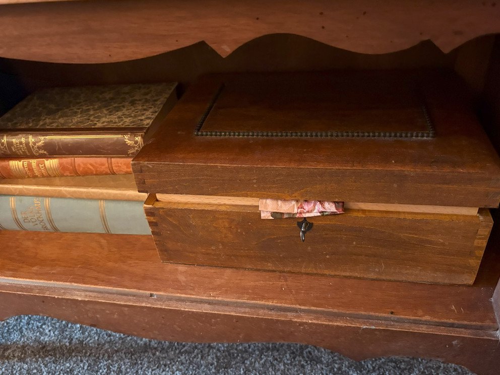Books and a box in the sideboard