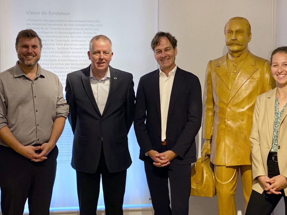 Tobi Rodrigue, Claude Genest, Christoph Barmeyer and Elisabeth Huber at the Soci&eacute;t&eacute; Historique d'Alphonse Desjardins wiht a statue of Alphonse Desjardins