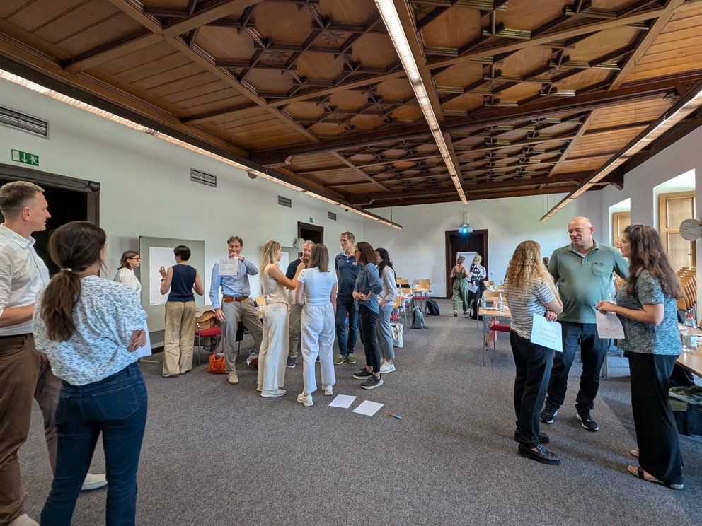 Participants discussing standing in small groups