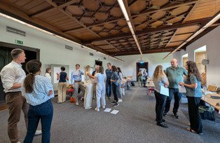 Participants discussing standing in small groups