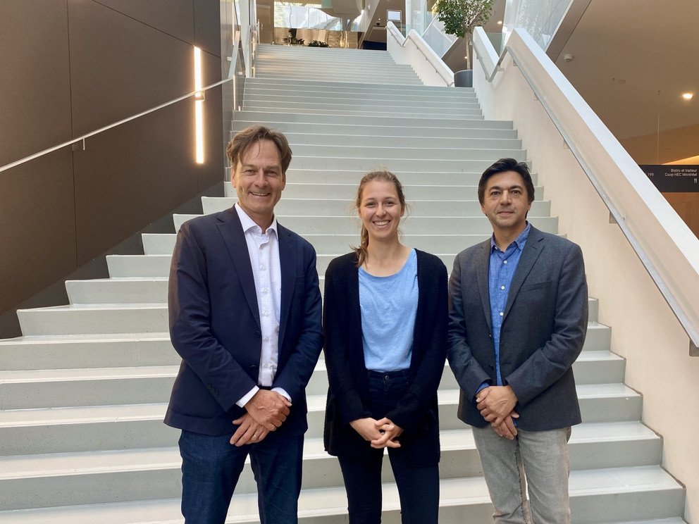 Prof. Dr. Christoph Barmeyer and Elisabeth Huber with Prof. Dr. Franck Bar&egrave;s in front of stair at HEC Montr&eacute;al