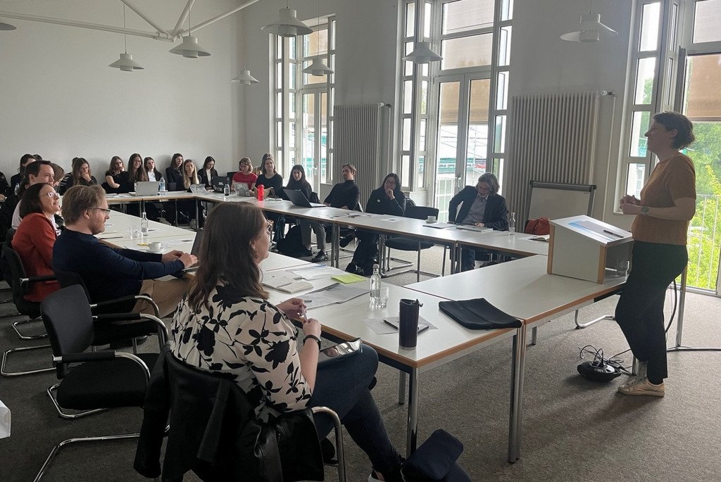 Photo of a speaker and some participants at the colloquium
