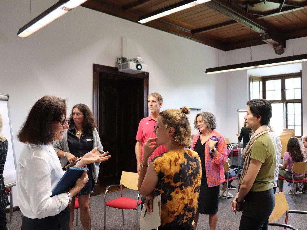 Two female participants discussing in a working group