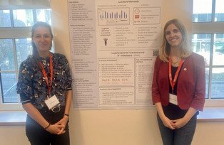 Elisabeth Huber and Rosanna Schropp next to their poster on German culture and "Mittelstand" (SMEs)