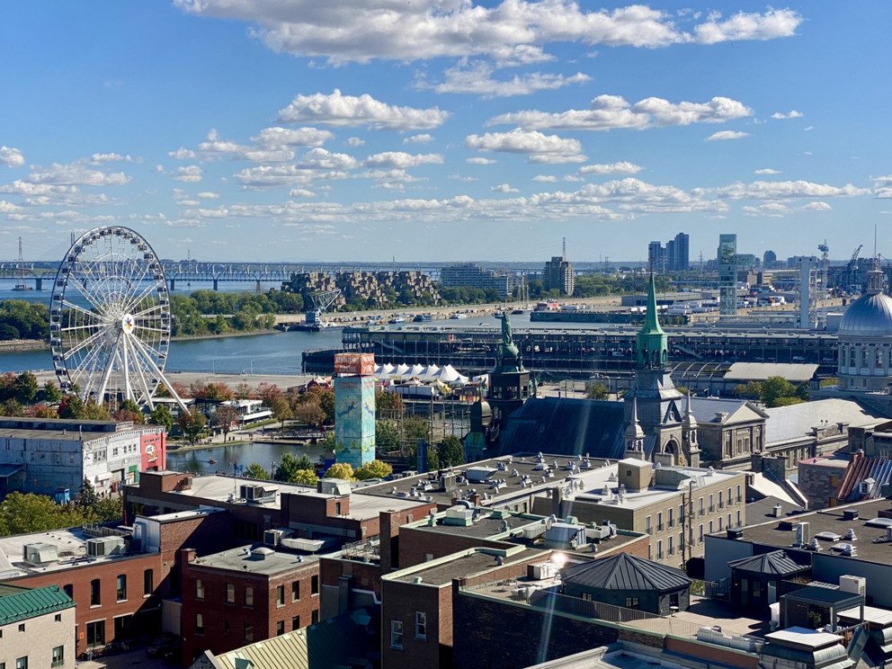 View over port of Montr&eacute;al with ferris wheel and different buildings