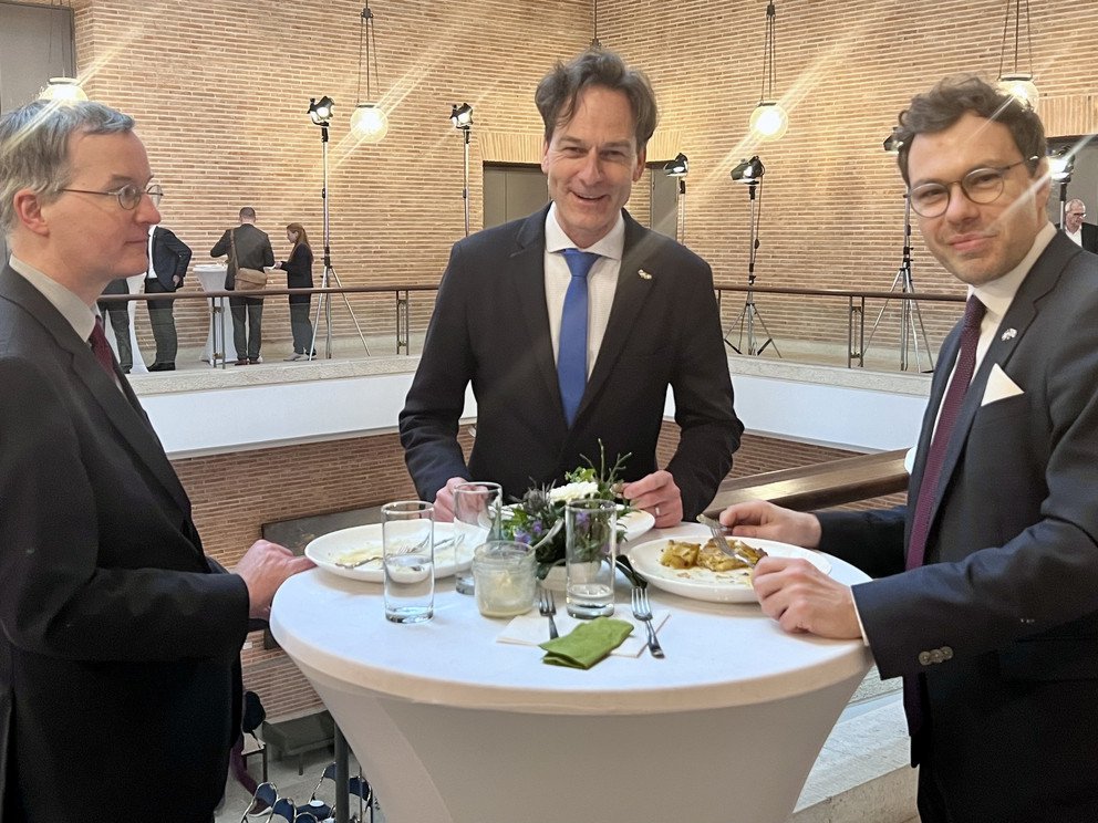 Three men eating together 