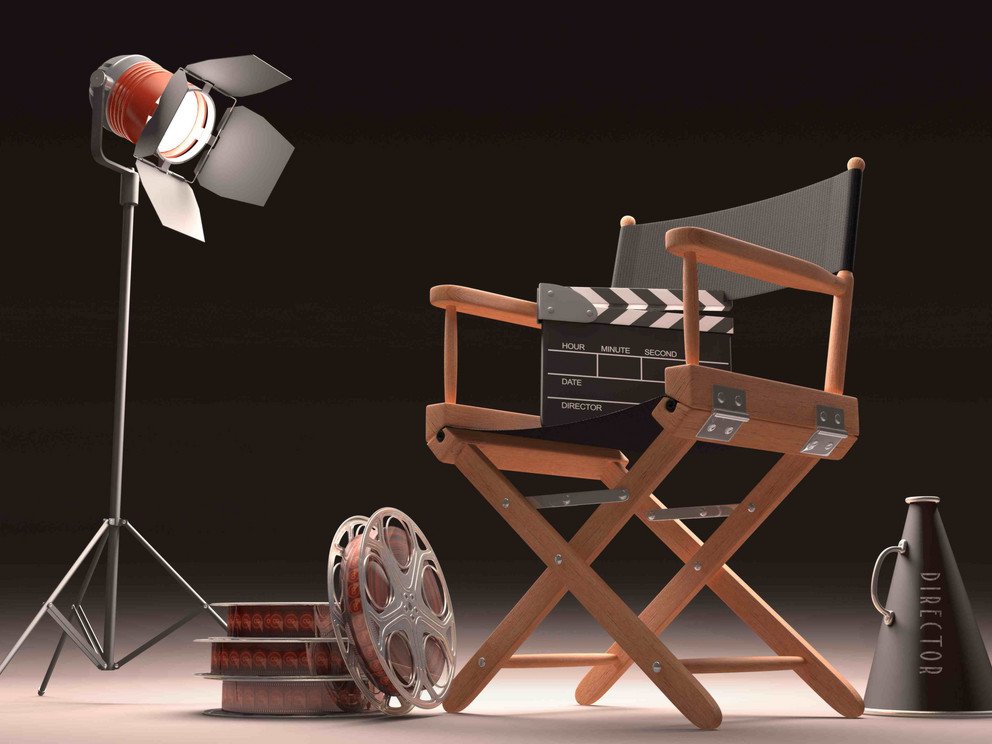 A director's chair in front of a black background